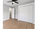 Bedroom featuring vinyl floors, light-gray walls, closet, and an ensuite bathroom with a marble shower at 190 Clydesdale Se Ln, Mableton, GA 30126