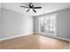 Light-filled bedroom with light-gray walls, vinyl floors, and large window overlooking mature landscaping at 190 Clydesdale Se Ln, Mableton, GA 30126