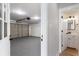 View from garage into a half bathroom with white cabinet and black faucet at 190 Clydesdale Se Ln, Mableton, GA 30126