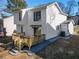 Rear exterior featuring a wood deck, white siding, and rock landscaping at 190 Clydesdale Se Ln, Mableton, GA 30126