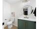 Modern powder room featuring stylish vanity, round mirror, and contemporary lighting at 2038 Cresthaven Walk, Woodstock, GA 30189