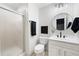 Bathroom featuring glass shower, modern vanity, round mirror, and new lighting at 2038 Cresthaven Walk, Woodstock, GA 30189