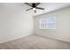 Bright bedroom with neutral carpet, ceiling fan, and a large window for natural light at 2038 Cresthaven Walk, Woodstock, GA 30189