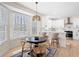 Breakfast nook featuring a modern light fixture and views of the updated kitchen and wooded backyard at 2038 Cresthaven Walk, Woodstock, GA 30189