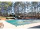 Large community pool with pool cover, slide, lounge chairs, and beautiful landscaping at 2038 Cresthaven Walk, Woodstock, GA 30189