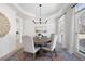 Elegant dining room featuring hardwood floors, modern chandelier, and large windows at 2038 Cresthaven Walk, Woodstock, GA 30189