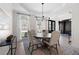 Stylish dining room with hardwood floors, modern decor, and ample natural light at 2038 Cresthaven Walk, Woodstock, GA 30189