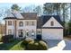 Charming home featuring stone accents, a two-car garage, and a professionally landscaped yard at 2038 Cresthaven Walk, Woodstock, GA 30189