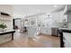 Bright, white kitchen featuring stainless steel appliances, stylish cabinets, hardwood floors and a breakfast nook at 2038 Cresthaven Walk, Woodstock, GA 30189