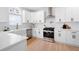 Modern kitchen featuring white cabinets, stainless steel appliances, white subway tile backsplash and quartz countertops at 2038 Cresthaven Walk, Woodstock, GA 30189