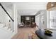 Cozy living room featuring fireplace, built-in bookshelves and hardwood floors, accessible from foyer at 2038 Cresthaven Walk, Woodstock, GA 30189