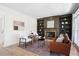 Spacious living room featuring a stone fireplace, built-in bookshelves, and large windows at 2038 Cresthaven Walk, Woodstock, GA 30189