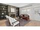 Inviting living room featuring hardwood floors, large windows and a stone fireplace with built-in bookshelves at 2038 Cresthaven Walk, Woodstock, GA 30189