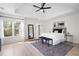 A beautifully decorated main bedroom offers a spacious layout, rug, and modern ceiling fan at 2038 Cresthaven Walk, Woodstock, GA 30189