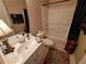 Bathroom featuring a single sink vanity, tile floors, toilet, and bathtub at 215 Kigian Trl, Woodstock, GA 30188