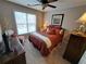 Bedroom with carpet, a large window, ceiling fan, and a dresser at 215 Kigian Trl, Woodstock, GA 30188