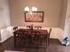 Traditional dining room with hardwood floors, a chandelier, and seating for six at 215 Kigian Trl, Woodstock, GA 30188