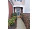 Inviting front entrance with decorative plants and sidelight, perfect for welcoming guests at 215 Kigian Trl, Woodstock, GA 30188