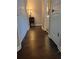 Hallway featuring hardwood floors, a view of the bathroom, and closet space at 215 Kigian Trl, Woodstock, GA 30188