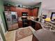 Functional kitchen with tile floor, stainless steel appliances and dark wood cabinetry at 215 Kigian Trl, Woodstock, GA 30188