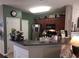 Cozy kitchen with stainless steel appliances, dark cabinets, and a breakfast bar at 215 Kigian Trl, Woodstock, GA 30188