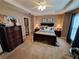 Main bedroom featuring a ceiling fan, carpeted floor, warm paint and wooden dresser at 215 Kigian Trl, Woodstock, GA 30188