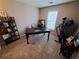 Home office with desk, chair, treadmill, bookshelf, and window offering natural light at 215 Kigian Trl, Woodstock, GA 30188