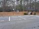 Visitor parking spaces available, located in a wooded area with a covered mailbox structure and waste disposal can at 215 Kigian Trl, Woodstock, GA 30188