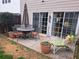 Outdoor patio featuring a dining set, bench, flower pots, and sliding doors at 215 Kigian Trl, Woodstock, GA 30188