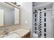 Bathroom featuring a shower with black and white accent tiles and granite countertops at 25309 Plantation Ne Dr # 309, Atlanta, GA 30324