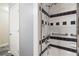 Bathroom featuring a shower with black and white accent tiles and grab bars at 25309 Plantation Ne Dr # 309, Atlanta, GA 30324