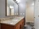 Bathroom featuring granite countertops, wood cabinetry, and a decorative mirror at 25309 Plantation Ne Dr # 309, Atlanta, GA 30324