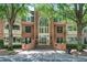 Elegant brick condo building featuring a grand entrance and mature trees at 25309 Plantation Ne Dr # 309, Atlanta, GA 30324