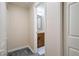 A hallway leading to a bathroom with gray tile flooring and neutral paint at 25309 Plantation Ne Dr # 309, Atlanta, GA 30324