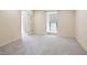 Neutral living room featuring a window and French doors with neutral color palette at 25309 Plantation Ne Dr # 309, Atlanta, GA 30324