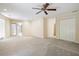 Bright living room with neutral walls, ceiling fan, and French doors leading to another room at 25309 Plantation Ne Dr # 309, Atlanta, GA 30324