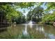 Tranquil view of a pond with a fountain surrounded by lush greenery at 25309 Plantation Ne Dr # 309, Atlanta, GA 30324