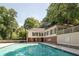 Large community pool surrounded by trees and a building in the background at 25309 Plantation Ne Dr # 309, Atlanta, GA 30324