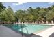 Inviting community pool surrounded by lounge chairs and lush greenery at 25309 Plantation Ne Dr # 309, Atlanta, GA 30324