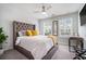 Bright bedroom with large, tufted headboard, comfy bedding and natural light at 2978 Edgemont Ln, Marietta, GA 30008