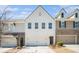 Well-maintained townhouse exterior featuring a two-car garage, brick accents, and modern design elements at 2978 Edgemont Ln, Marietta, GA 30008