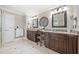 Spacious bathroom featuring double vanities, granite countertops, and decorative wall accents at 9795 Terrace Lake Pointe, Roswell, GA 30076