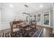 Formal dining room features a table set for six, a buffet, and access to screened porch at 9795 Terrace Lake Pointe, Roswell, GA 30076