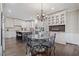 Eat-in kitchen with glass table, black iron chairs, island, and built-in white cabinetry at 9795 Terrace Lake Pointe, Roswell, GA 30076