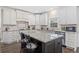 This is a kitchen with a large island, white cabinets, and granite countertops at 9795 Terrace Lake Pointe, Roswell, GA 30076