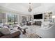 A cozy living room with large windows, built-in shelving, and a fireplace at 9795 Terrace Lake Pointe, Roswell, GA 30076