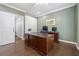 Well-lit home office featuring built-in shelving, a modern desk, and a stylish sliding barn door at 9795 Terrace Lake Pointe, Roswell, GA 30076