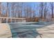 Community pool, covered for the off season, surrounded by a concrete deck and pergola at 2678 Stockbridge Way, Dacula, GA 30019