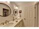 Bathroom featuring double sinks, round mirrors, and plenty of storage at 309 Berkeley Woods Dr, Duluth, GA 30096