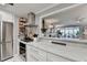 Well-designed kitchen with stainless steel range hood and pass-through to the living room at 309 Berkeley Woods Dr, Duluth, GA 30096